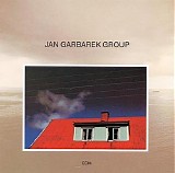Jan Garbarek - Photo With Blue Sky, White Cloud, Wires, Windows And A Red Roof